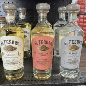Three varieties of El Tesoro tequila bottles.