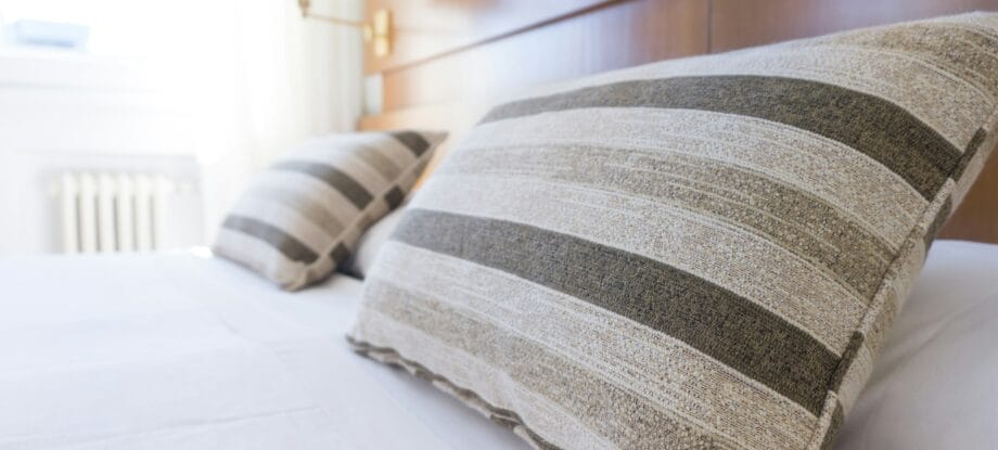 Two striped pillows on a neatly made bed.