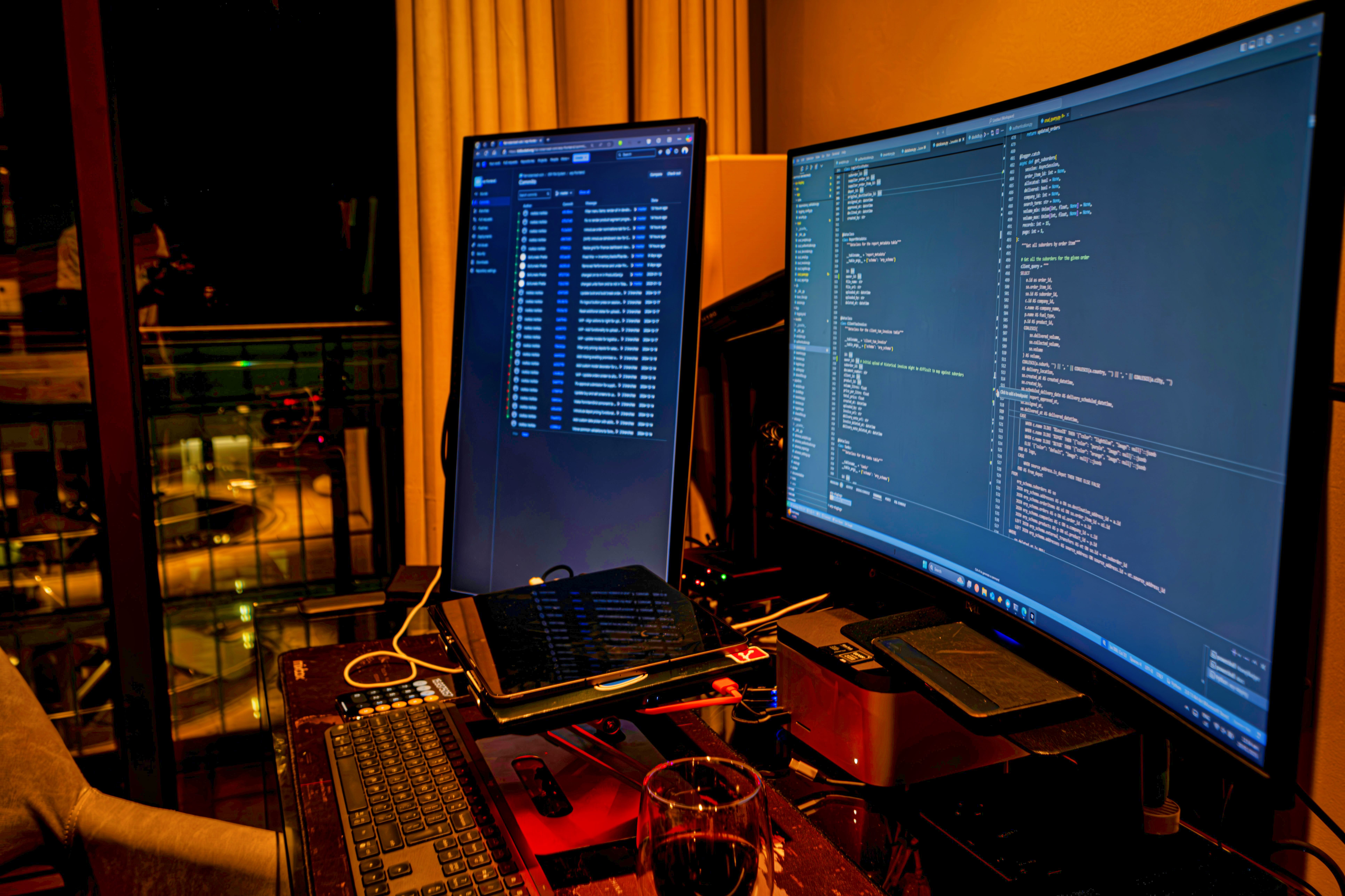 Dual monitors displaying code in home office setup