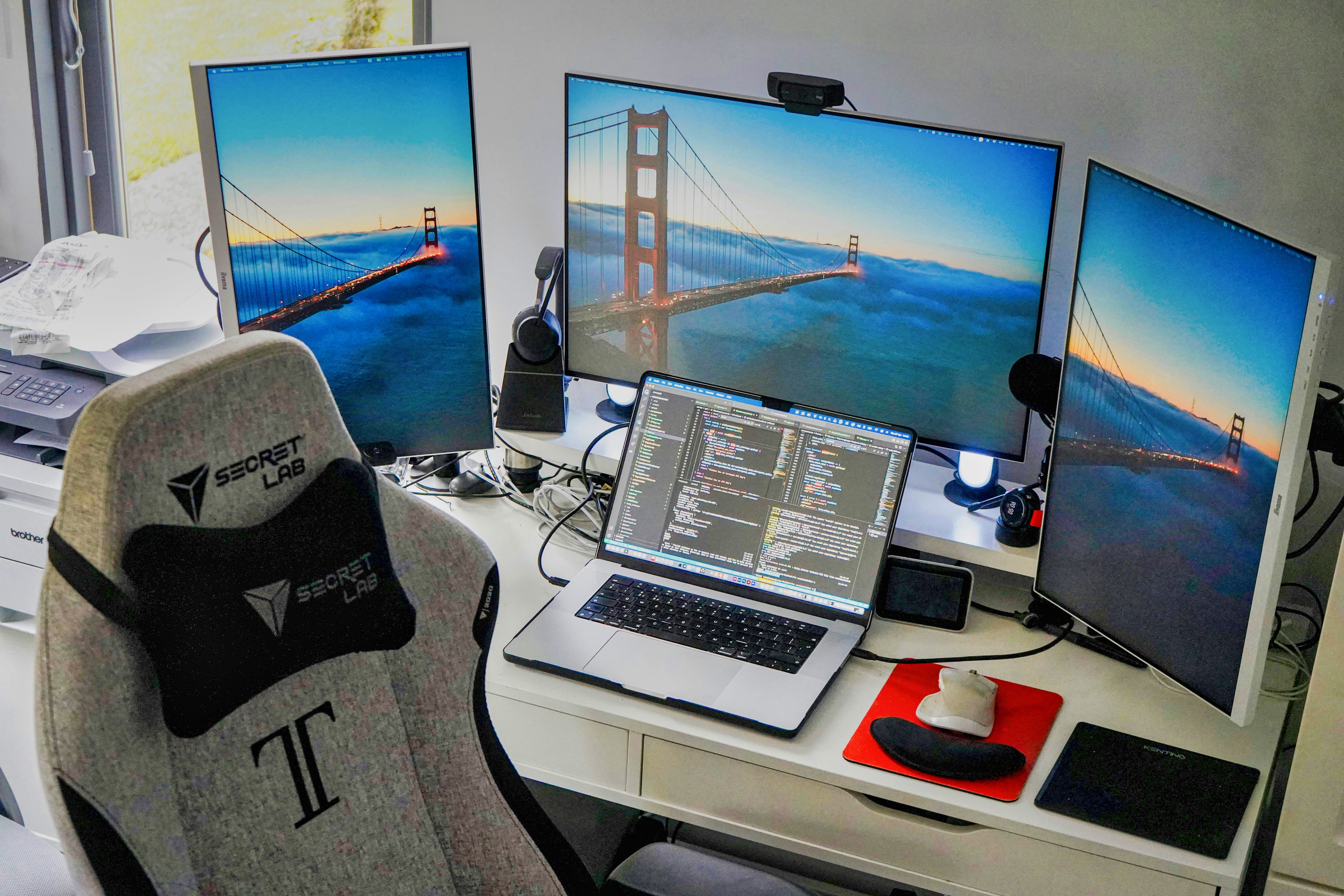 Modern home office with multiple monitors and laptop