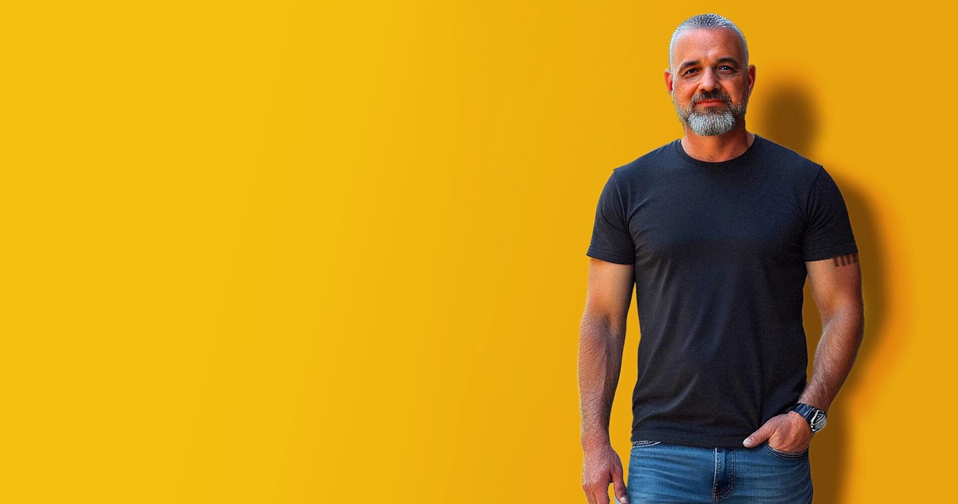 Man in black t-shirt against yellow background