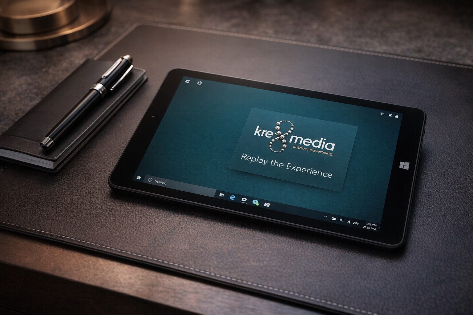 Tablet displaying marketing company logo on desk